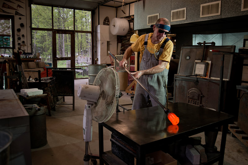 A man works in a glass maker's workshop.